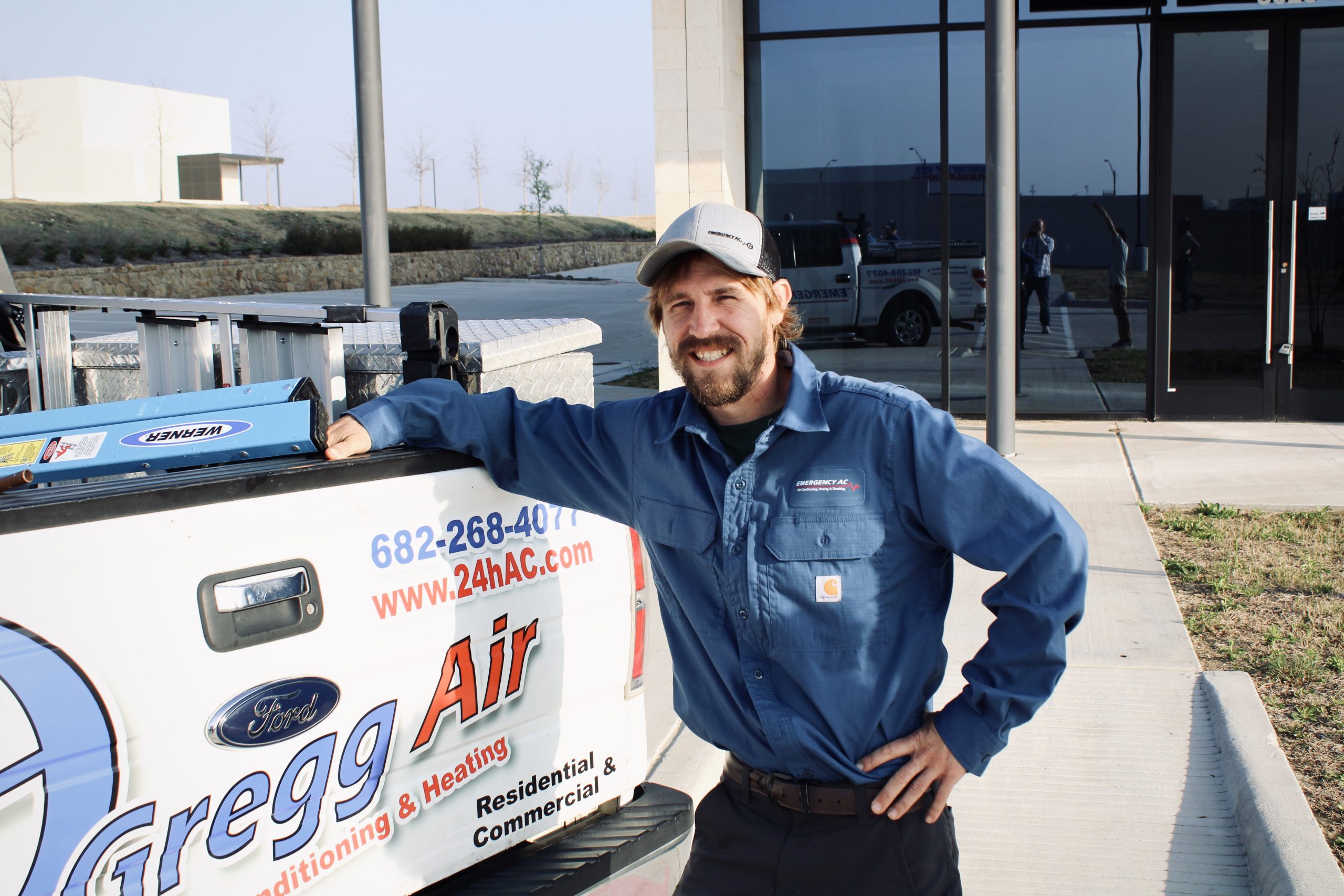 Emergency AC plumber in front of truck